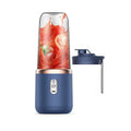Portable blue electric blender with a clear cup containing tomato juice and a matching blue travel lid.