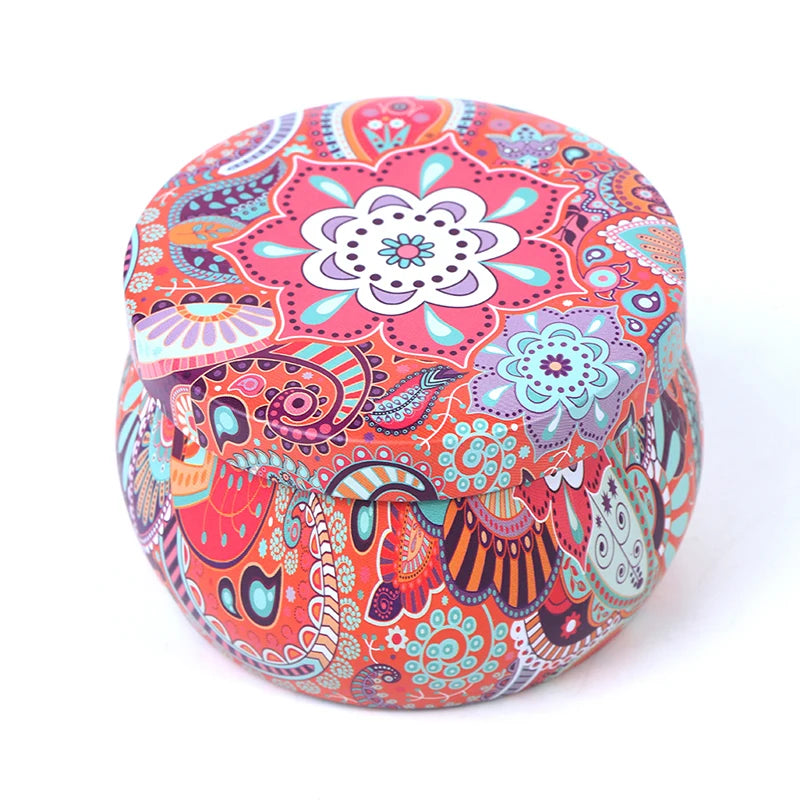 Small round metal storage tin featuring a vibrant, multi-coloured bohemian mandala and paisley pattern.