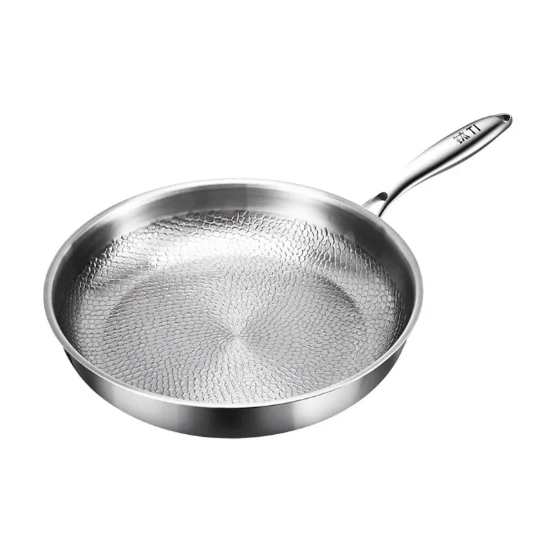 A silver frying pan with a textured, hammered interior and a long handle on a white background.