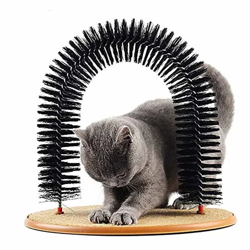A grey cat uses a black bristled grooming arch attached to a round, tan-coloured textured scratching base.