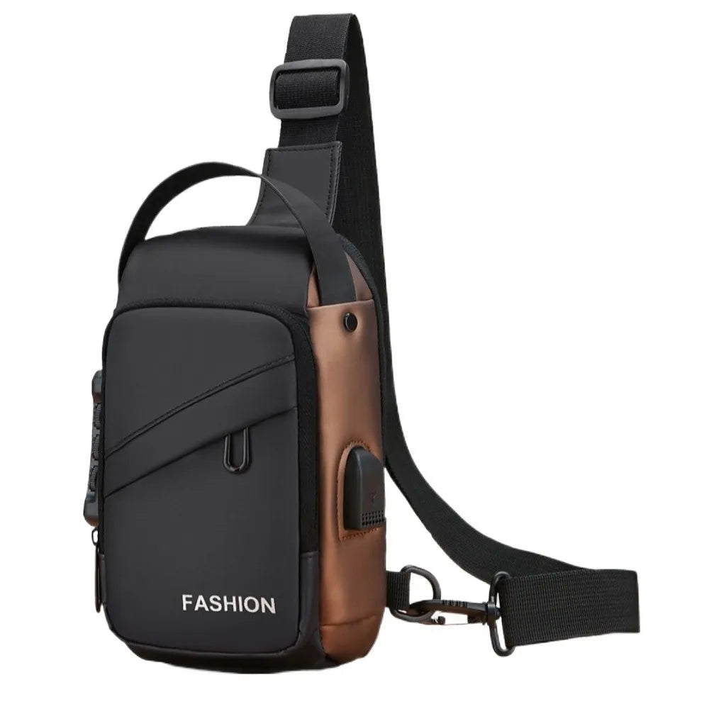 Black and bronze crossbody chest bag with an adjustable strap, top handle, and side USB charging port.