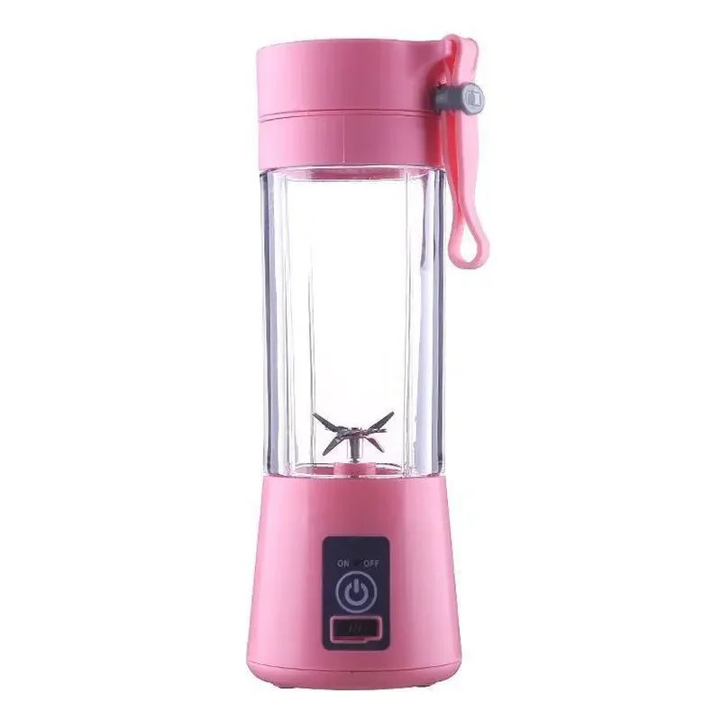 Portable pink personal blender with a clear mixing cup, stainless steel blades, and a power button on the base.