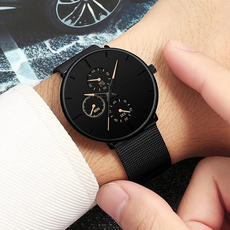 Men's ultra-thin black quartz watch with a mesh stainless steel strap and rose gold detailing on the dial.