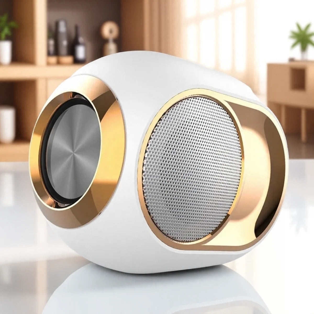White and gold portable Bluetooth speaker with a sleek, spherical design and metal mesh detailing.