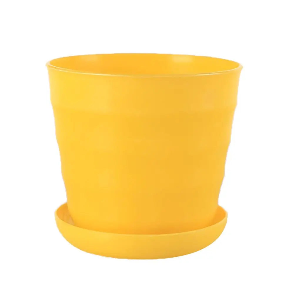 Bright yellow plastic flower pot with a matching saucer, featuring a modern, slightly ridged cylindrical design.