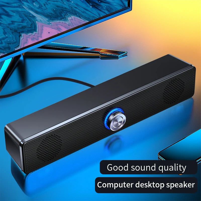 Sleek black USB-powered stereo soundbar for PC, featuring a central silver volume dial with a blue glowing LED light.