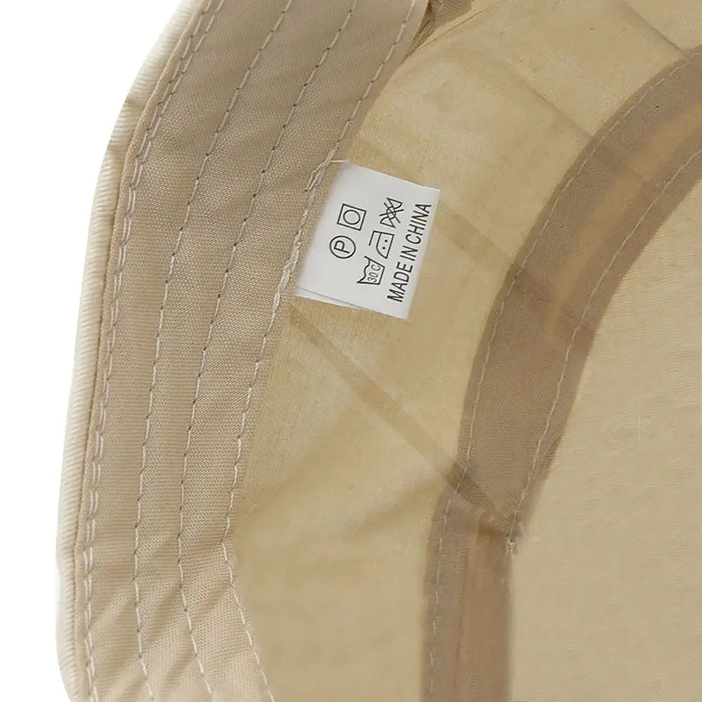 Close-up of the beige inner lining and care label of a breathable cadet baseball cap.