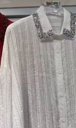 White button-down shirt with vertical shimmering stripes and an embellished rhinestone collar.