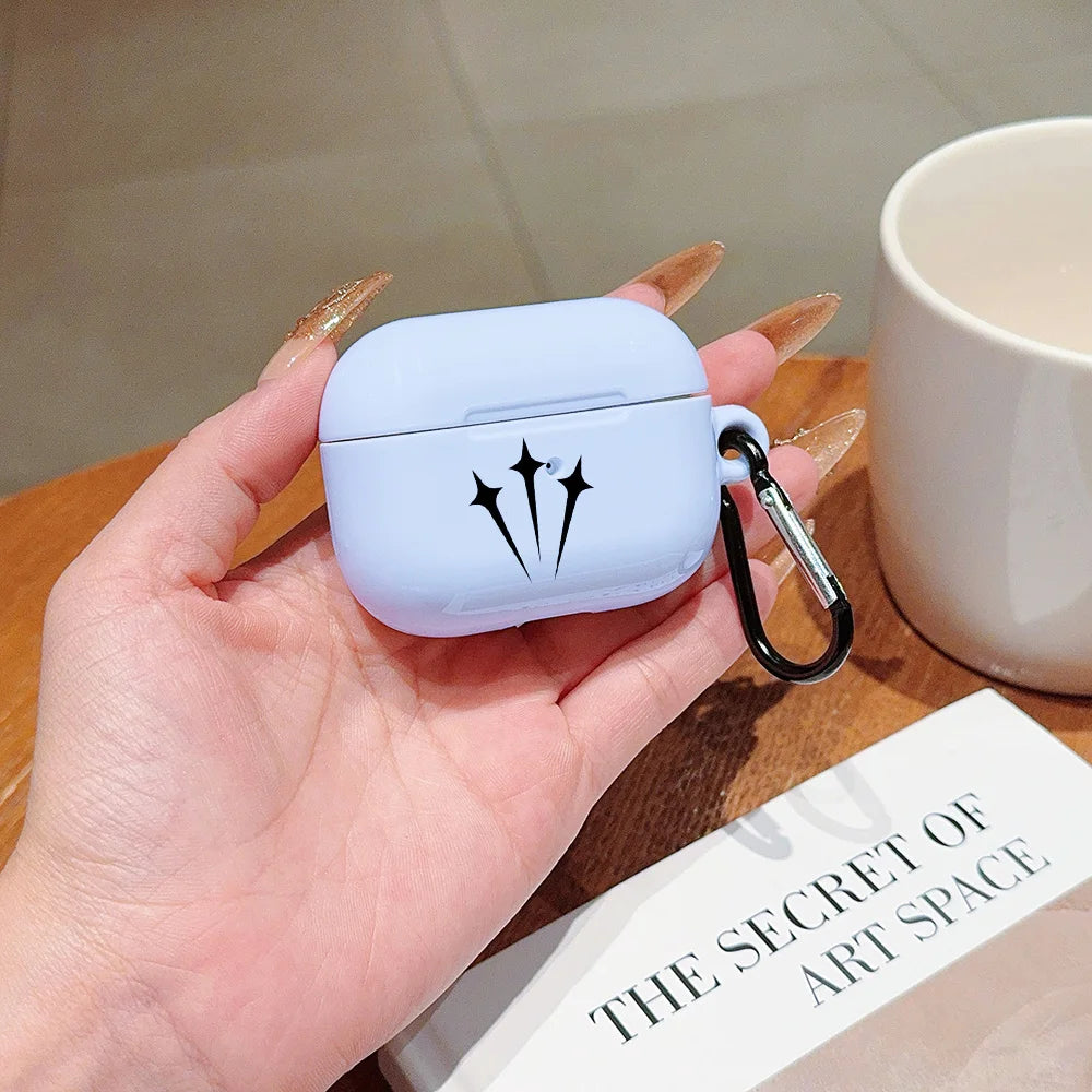 Pale blue silicone AirPod Pro case with black star detail and black carabiner held in hand.
