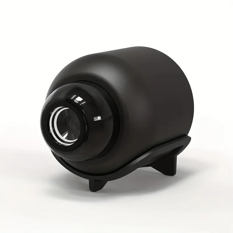 Compact, matte black wireless security camera with a glossy spherical lens, mounted on a sleek, stable stand.