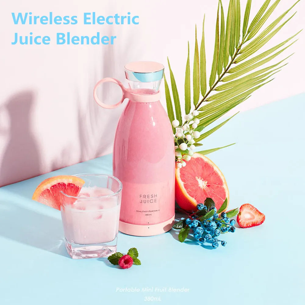 Pink portable wireless electric juice blender with a bottle-style design, set with fruit and a glass of smoothie.