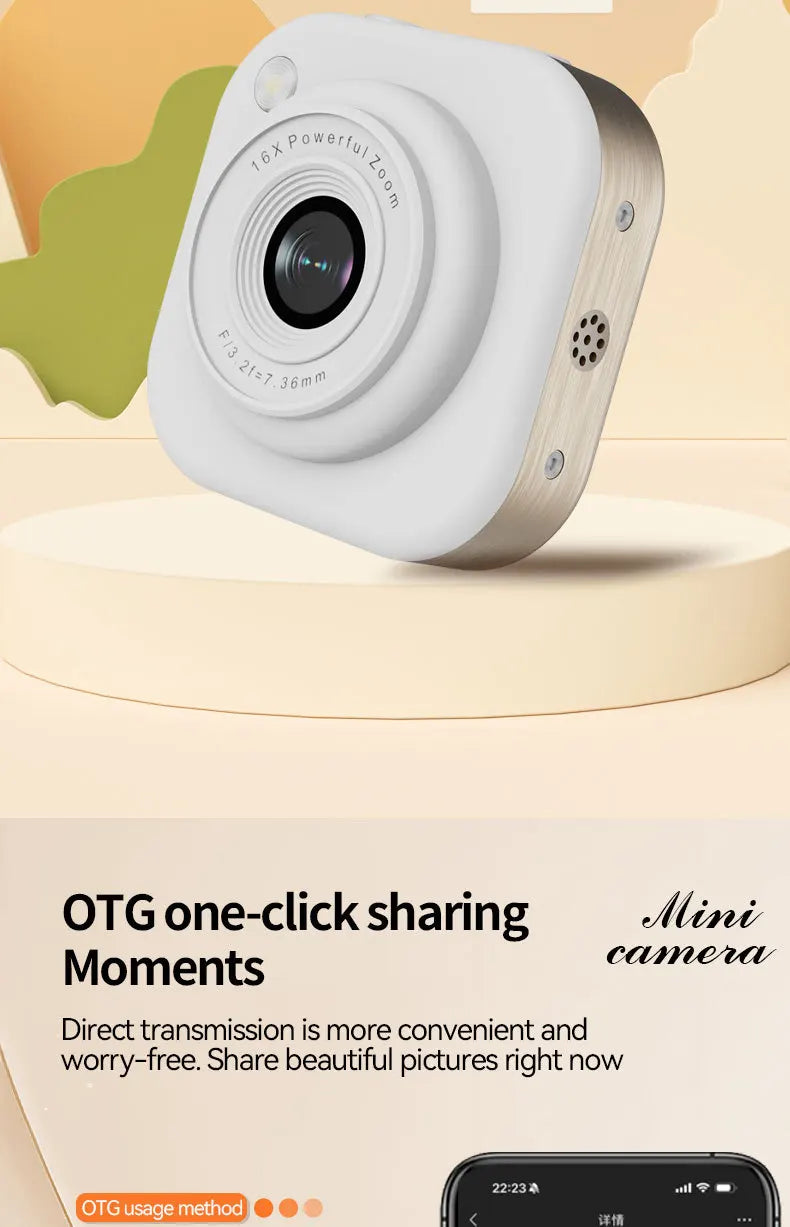 Small white and brushed metal mini camera with a lens featuring 16x zoom and speaker grill, on a circular stand.