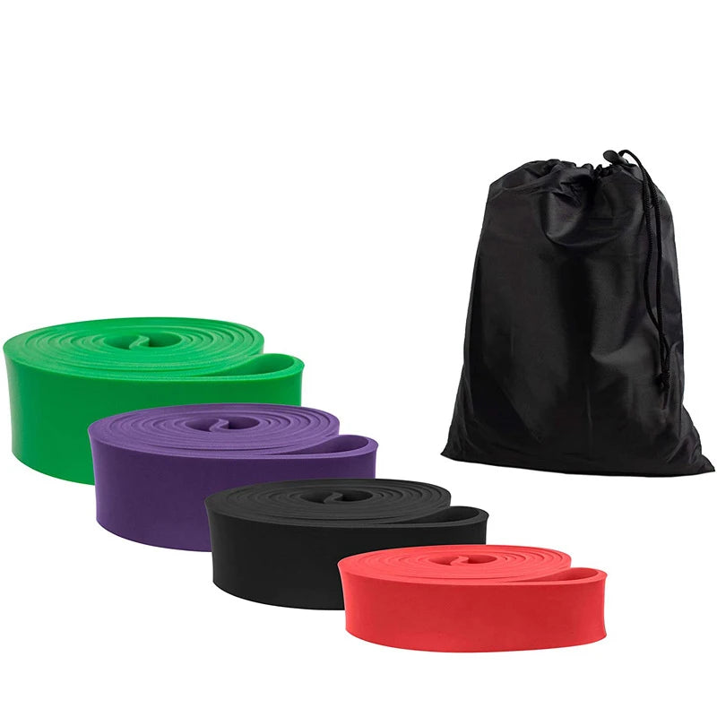 Four flat resistance bands in green, purple, black, and red, arranged with a black drawstring storage bag.