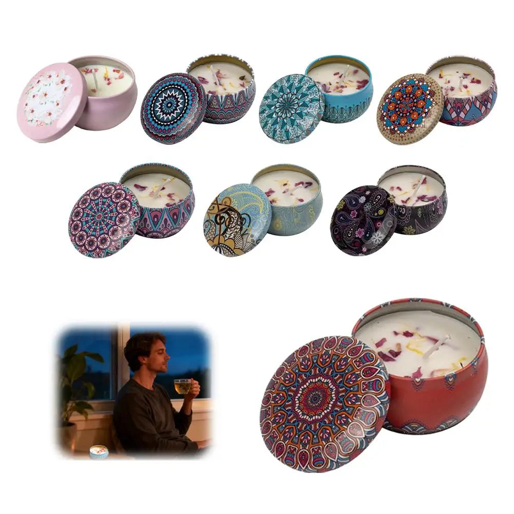 Assorted scented candles in decorative patterned metal tins with lids, featuring dried flower petals on white wax.