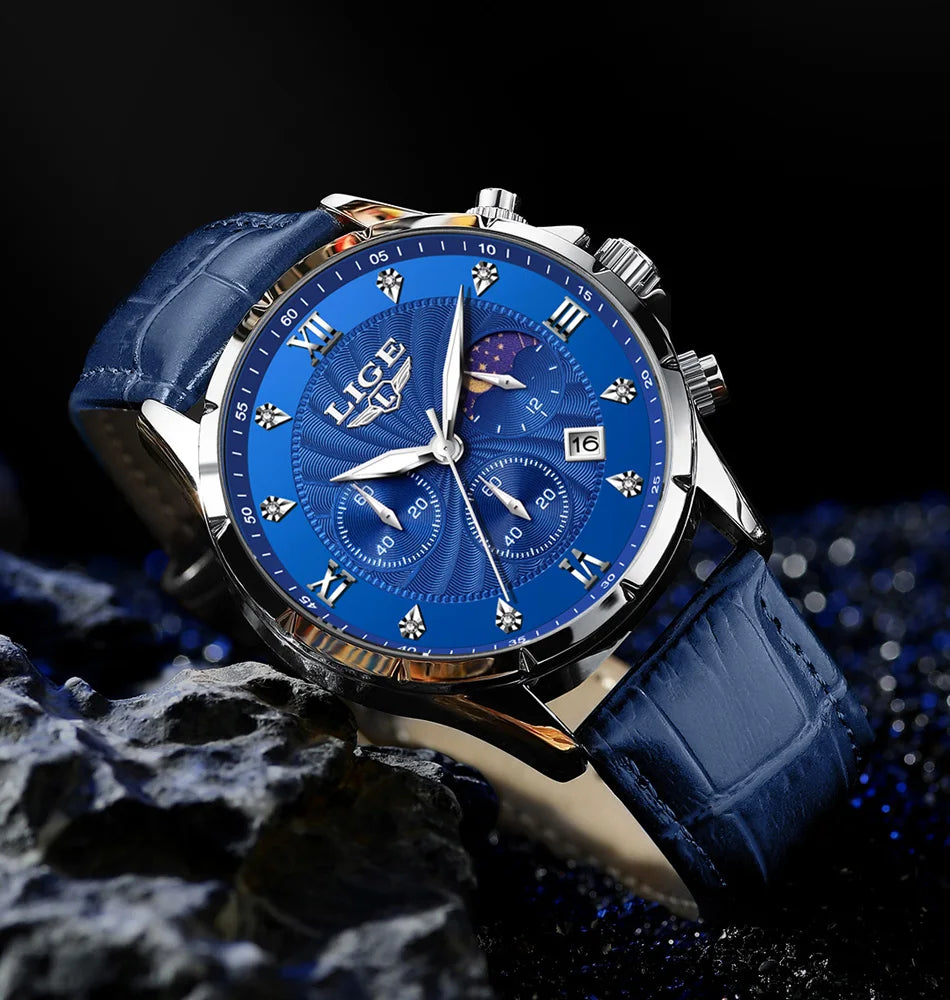 Men's chronograph watch with a blue embossed leather strap, silver case, and blue dial with moon phase and date window.