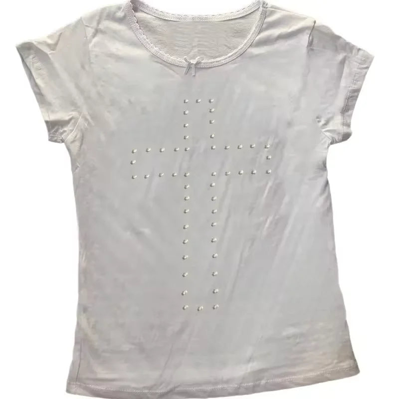 White short-sleeved T-shirt with a stud-embellished cross design, featuring a delicate lace trim and ribbon bow neckline.