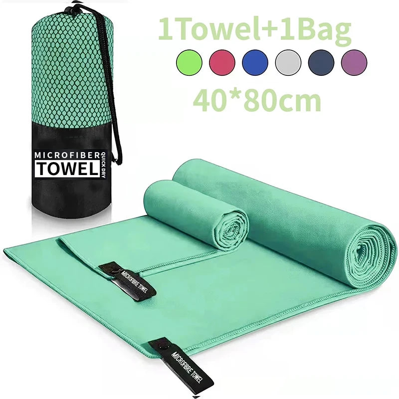 Mint green microfibre quick-dry towel set with a matching drawstring carry bag, shown unfolded and rolled.