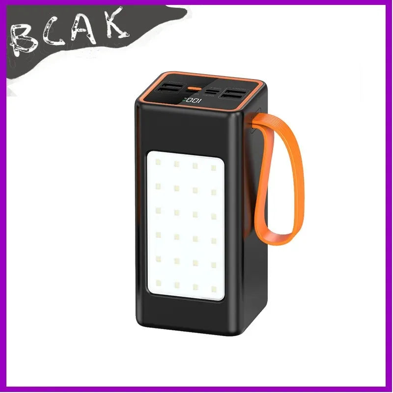Black portable power bank with orange strap, LED battery display, multiple output ports, and a front LED light panel.