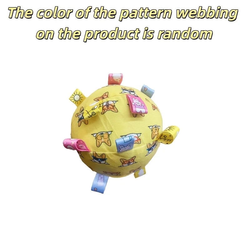 Yellow interactive dog ball featuring a cartoon corgi print, with small, multicoloured fabric tags sticking out.