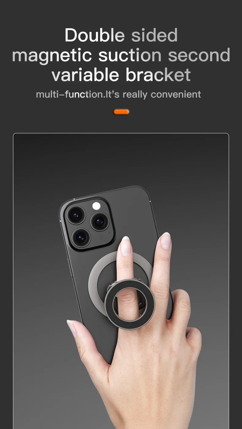 Black magnetic ring phone holder attached to a smartphone, being held by a finger.
