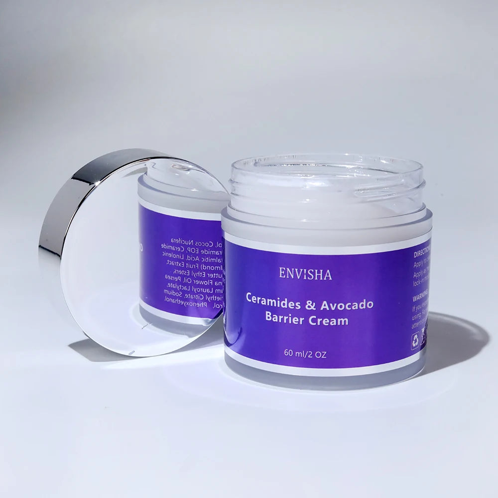 Open jar of Ceramides & Avocado barrier cream with a silver lid, featuring a purple label, 60ml/2oz size.