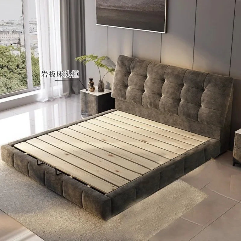 Modern luxury bed frame in dark grey tufted velvet with a low-profile design and natural wooden slatted base.