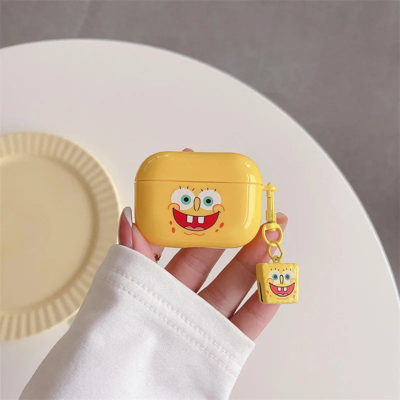 Yellow, glossy silicone SpongeBob AirPods Pro case with a matching character charm keyring.