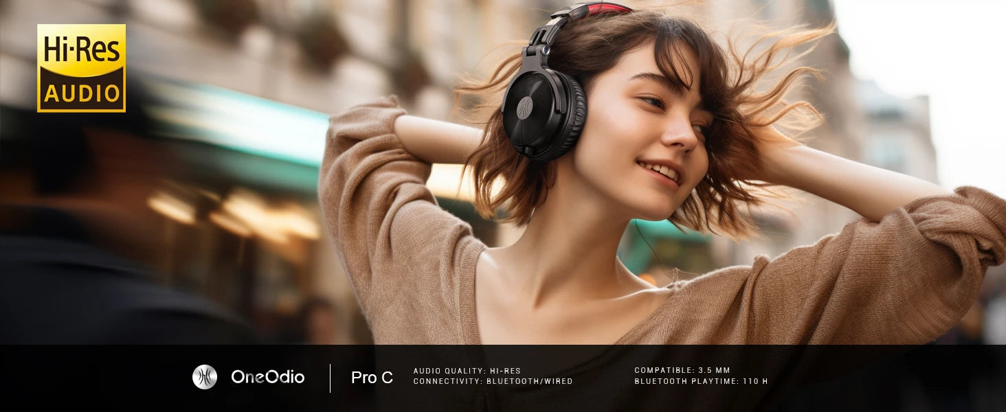 Woman wearing black wireless over-ear headphones with cushioned earcups and red headband detailing.