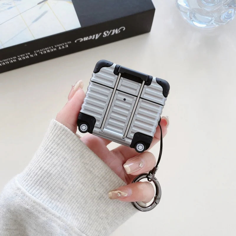 Silver luggage-style AirPods Pro case made of durable, ridged material with a keychain attachment.