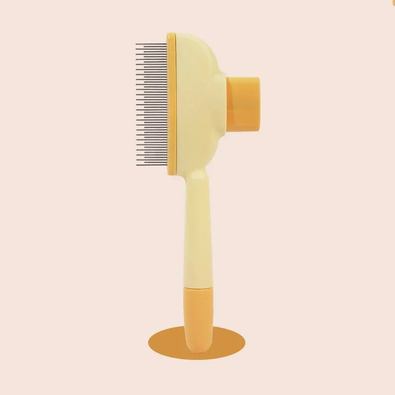 Cream and yellow pet grooming comb with metal teeth, standing upright on a round base against a light background.