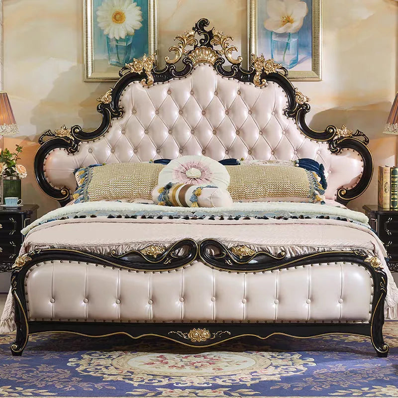 Ornate cream and black double bed with a tufted, padded headboard and decorative gold-toned carvings.