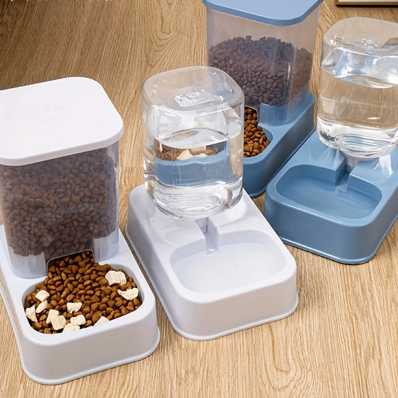 Automatic pet food and water dispensers in blue and white, featuring gravity-fed clear containers on a wooden floor.