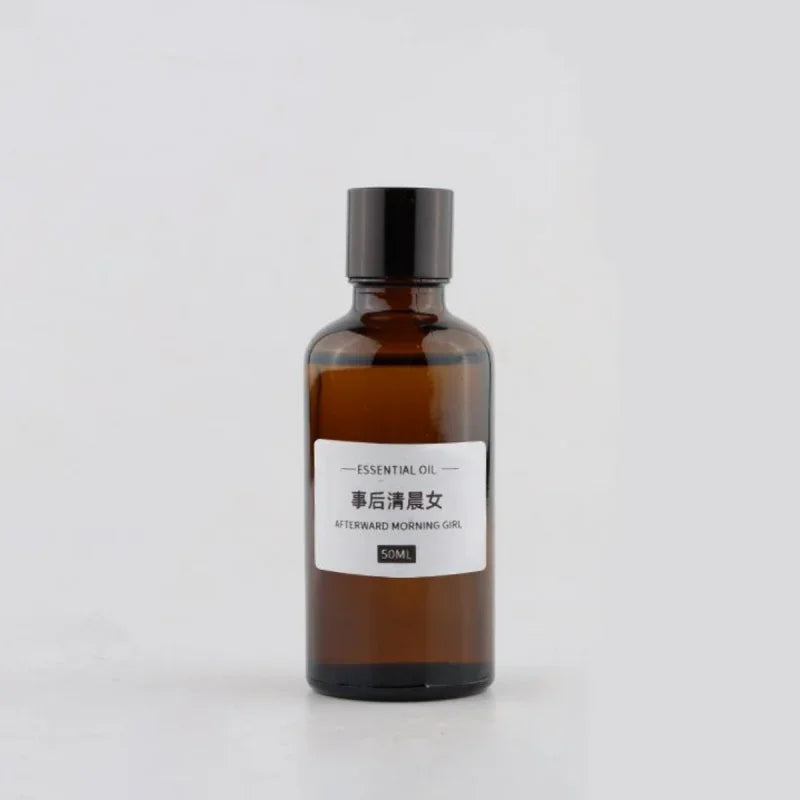 50ml amber glass bottle of essential oil with a black screw cap and minimalist white product label.