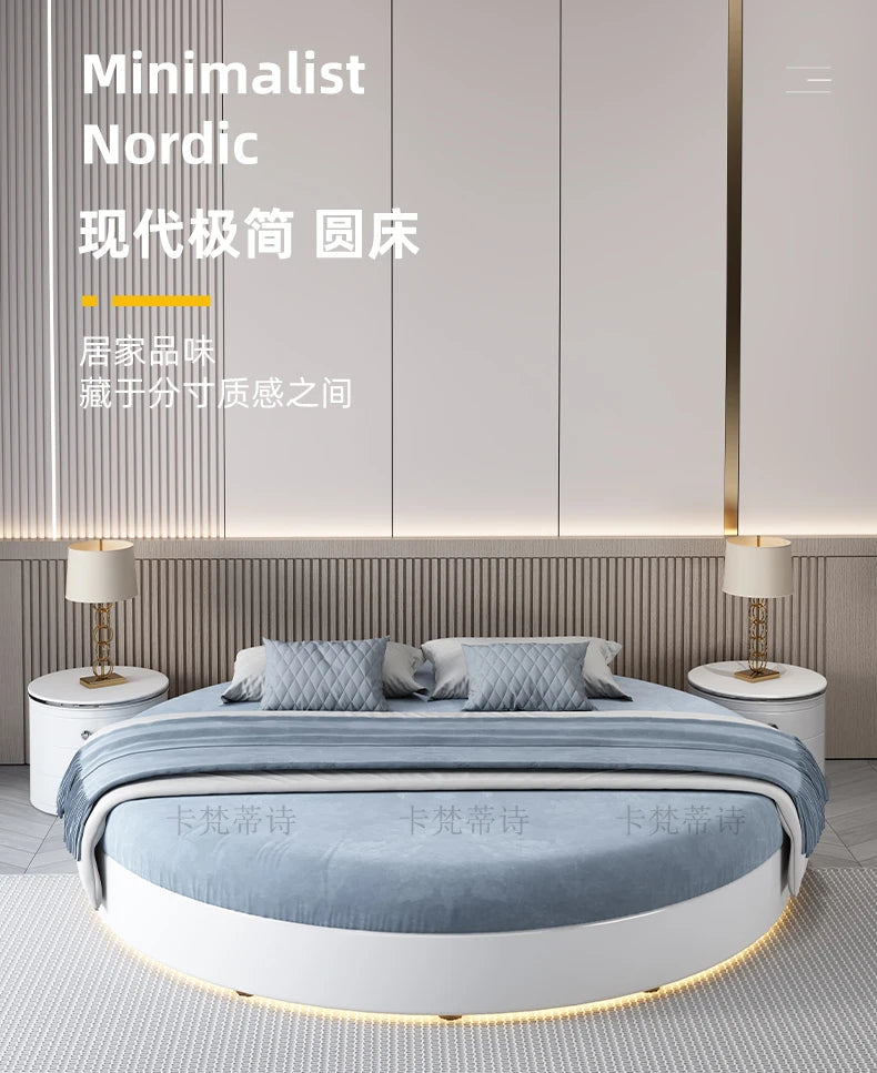 Modern minimalist round double bed frame in white with soft blue bedding and integrated under-bed lighting.