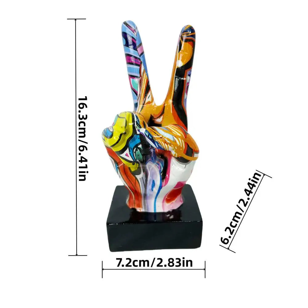 Colourful graffiti-style peace sign hand sculpture on a black square base. Measures approx. 16cm tall.