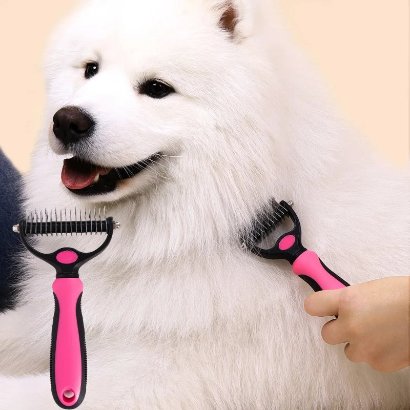 Pink and black dual-sided dog grooming rake being used on a white fluffy Samoyed dog.