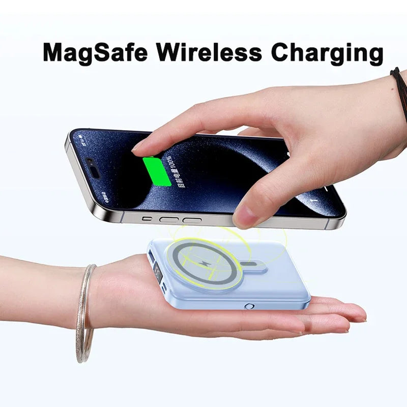 A hand holds a compact, light blue magnetic power bank wirelessly charging a smartphone.