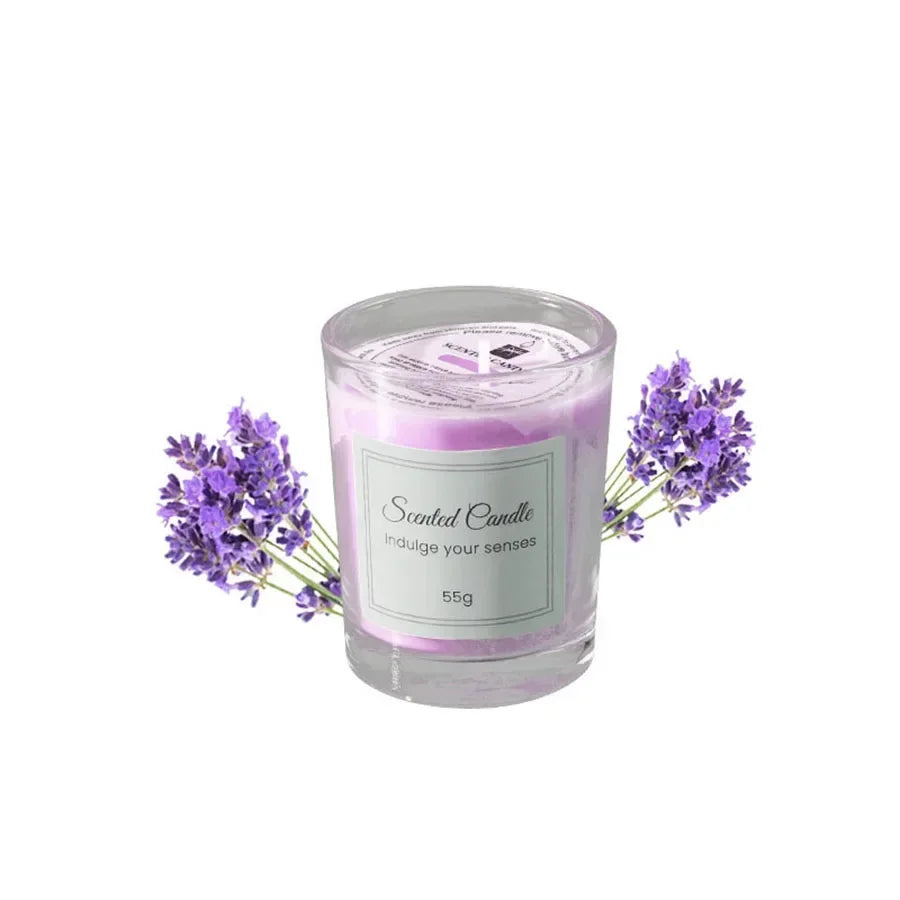 Purple lavender-scented candle in a glass votive jar, decorated with sprigs of fresh lavender flowers.