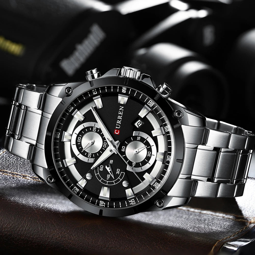 Luxury men’s watch with a black dial, silver stainless steel bracelet, multiple subdials and a date display.