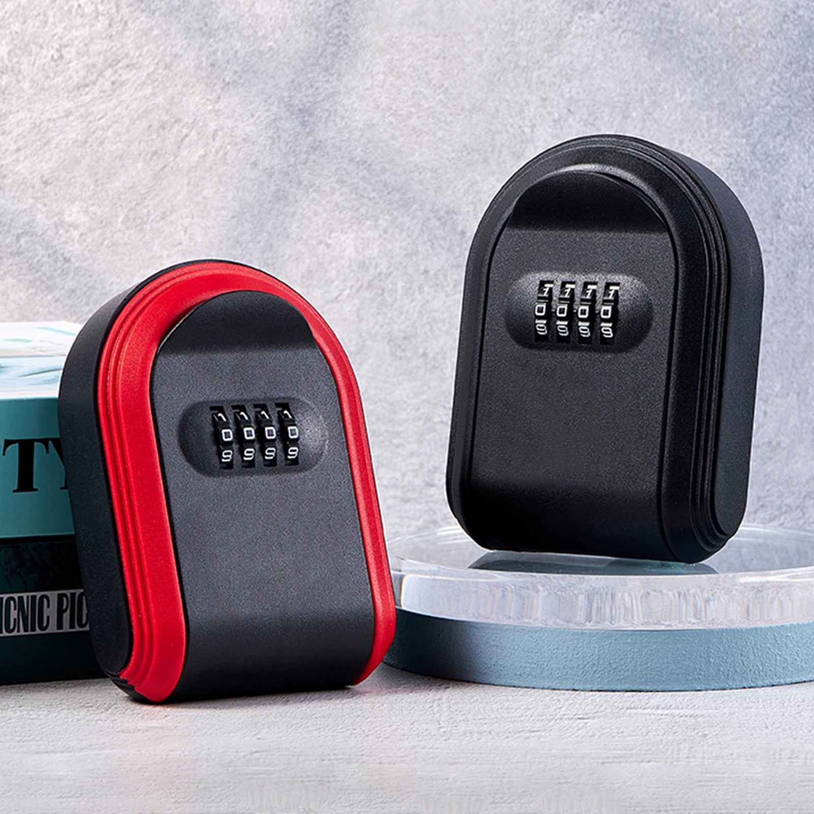 Two black and red metal key lock boxes with four-digit combination dials.