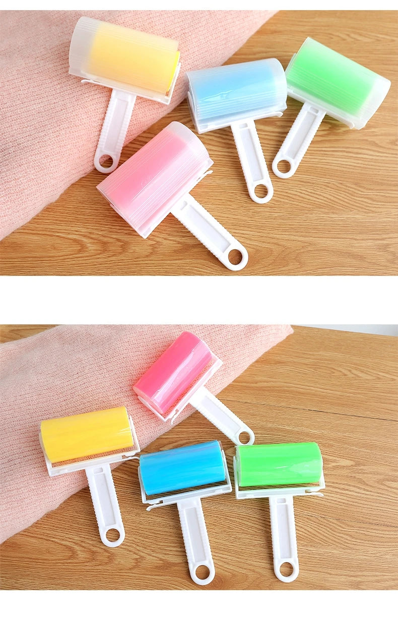 Assorted reusable lint rollers with white handles and colourful, sticky silicone heads on a wooden surface.
