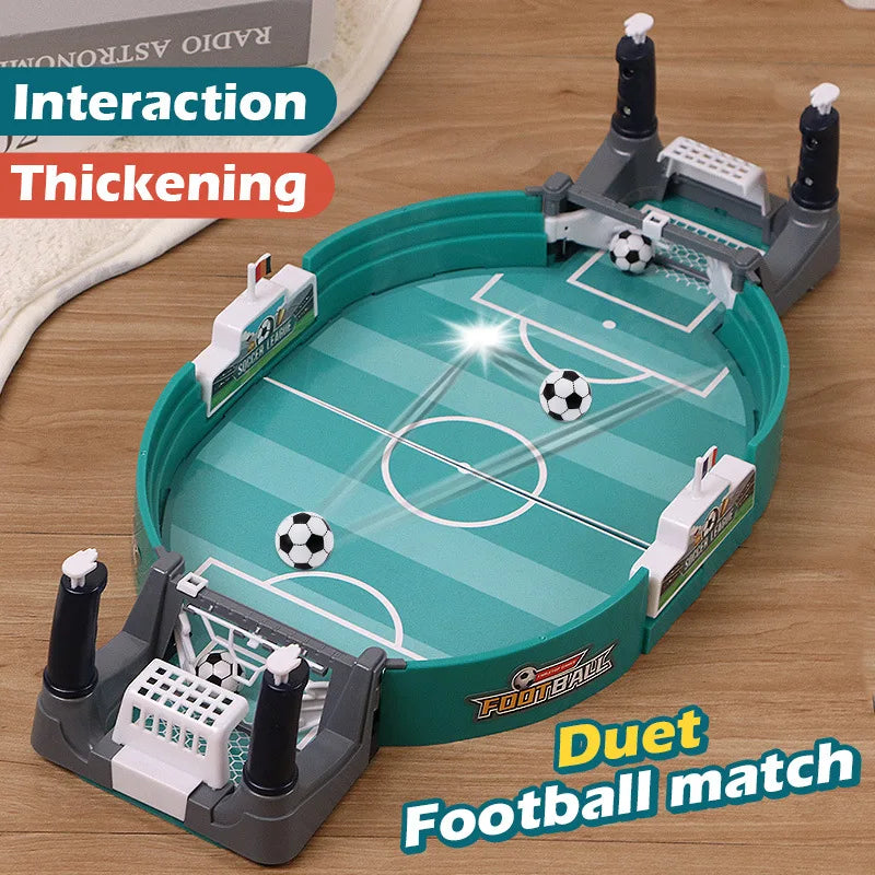 Tabletop football game with a teal oval pitch, goals, and miniature soccer balls for two-player interactive play.