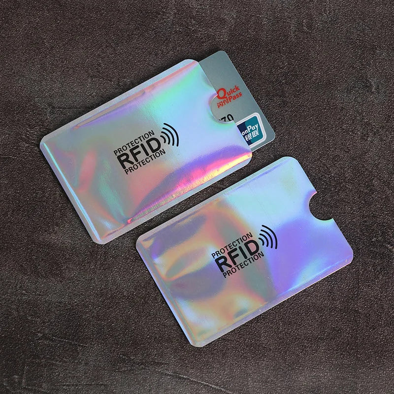 Two iridescent RFID-blocking card sleeves made of thin flexible plastic, one holding a credit card.