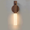 Wall-mounted wooden LED night light with a motion sensor and a warm, glowing frosted glass base.