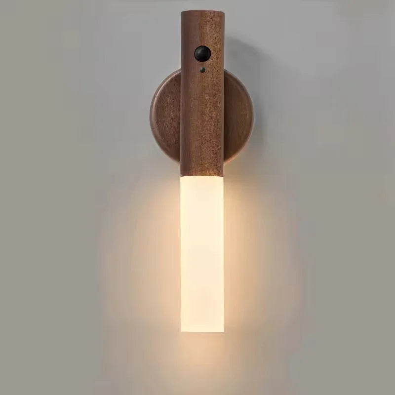 Wall-mounted wooden LED night light with a motion sensor and a warm, glowing frosted glass base.
