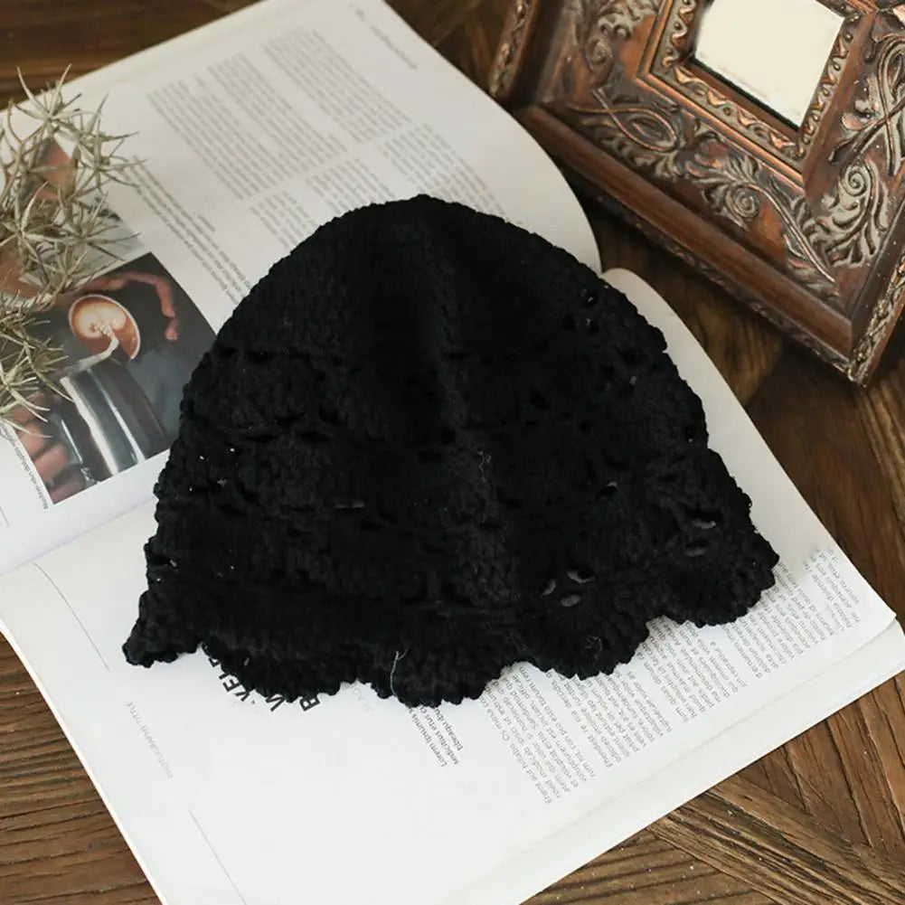 Black crochet lace beanie hat with a delicate hollow-knit pattern and scalloped edge.