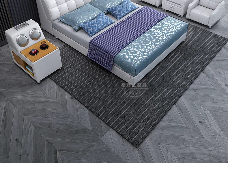 Modern white storage bed featuring a button-tufted padded headboard and a stylish, multi-patterned blue bedding set.