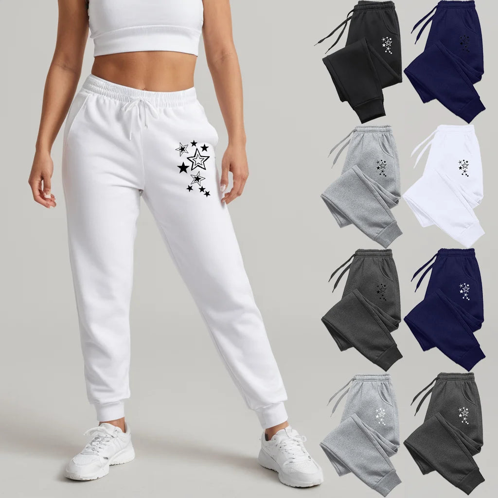 Women's high-waisted jogger pants with a star print, featuring an elastic drawstring waist and cuffed ankles.