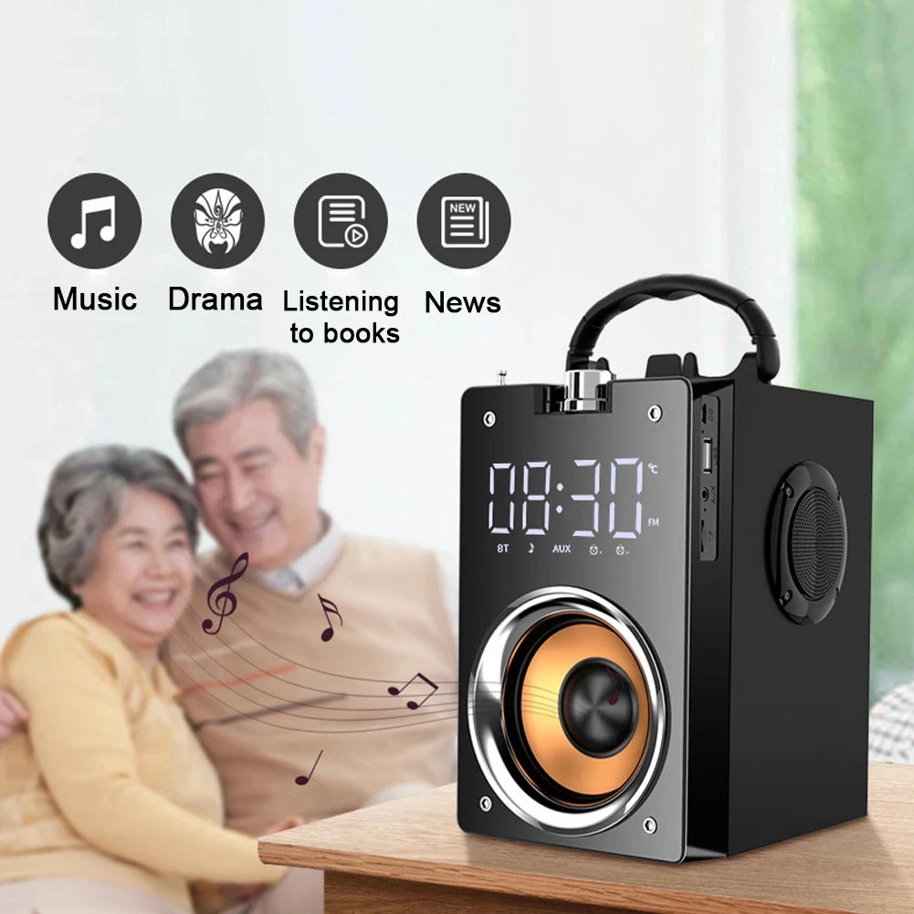 Portable black wireless speaker with digital clock, carry handle, and copper-toned speaker driver on a wooden table.