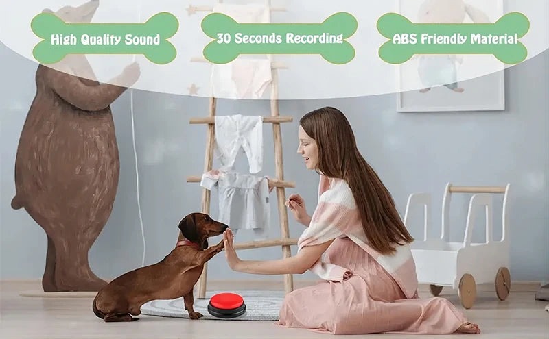 A person sits on the floor interacting with a dachshund next to a circular, red-topped dog training recordable button.